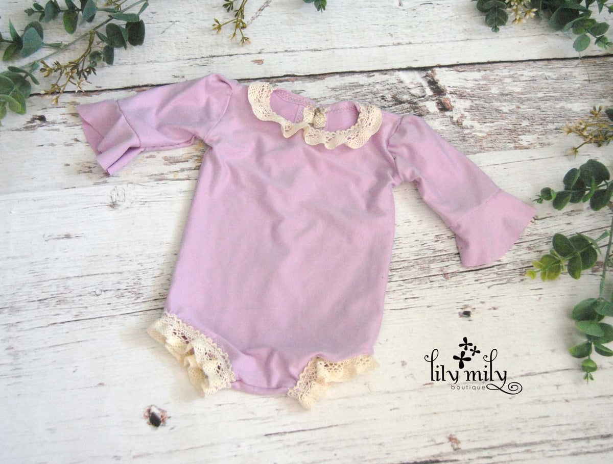 Newborn Violet Romper, Flutter Sleeves, and trimmed in crochet lace.