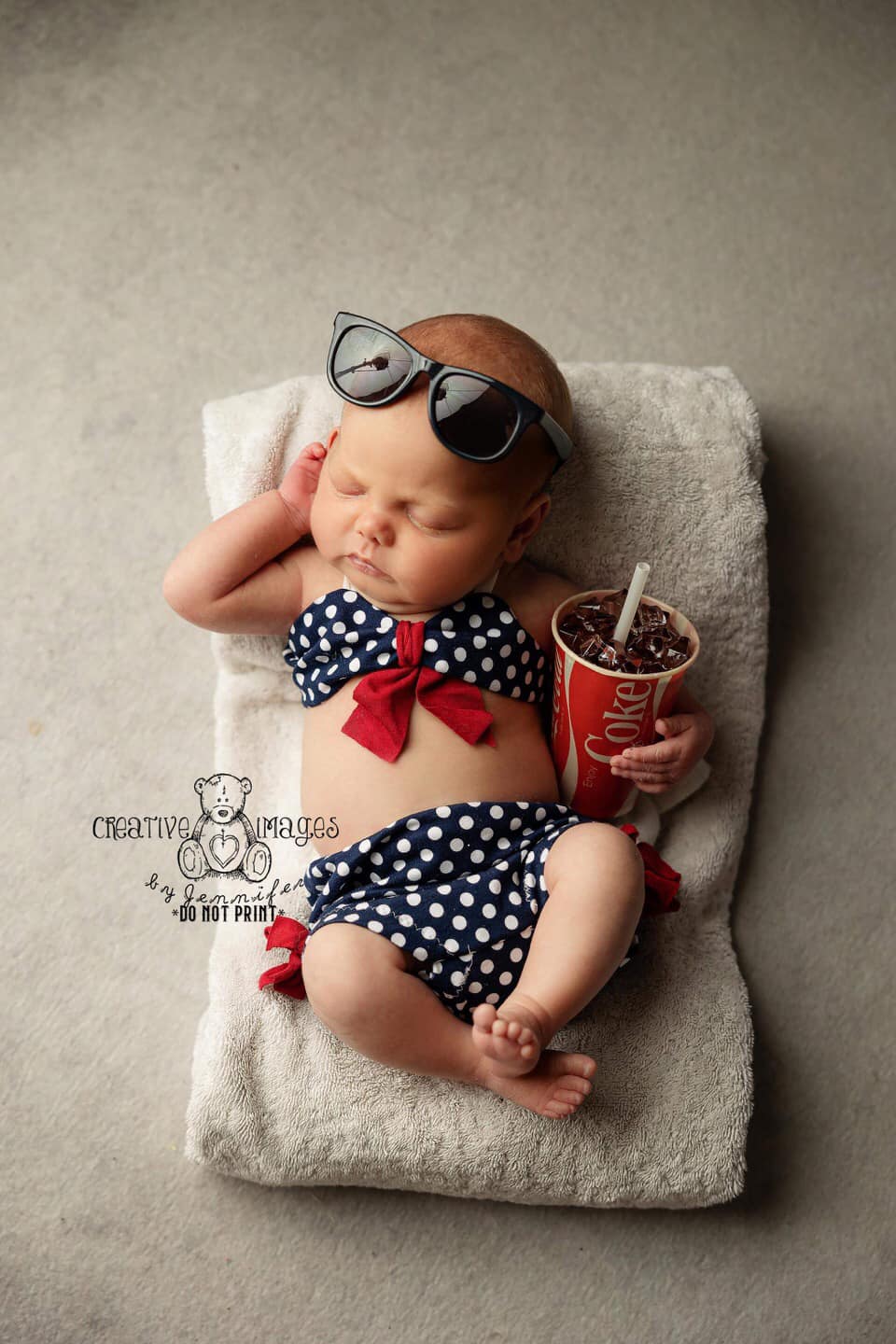 Newborn blue and white polka dot bikini.