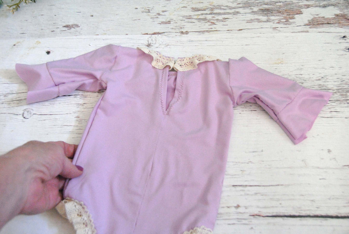 Newborn Violet Romper, Flutter Sleeves, and trimmed in crochet lace.