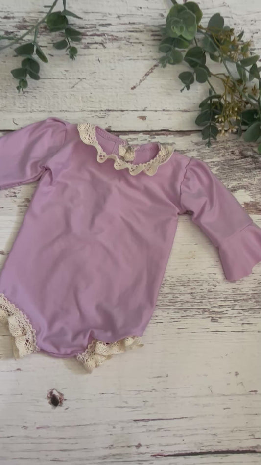 Newborn Violet Romper, Flutter Sleeves, and trimmed in crochet lace.